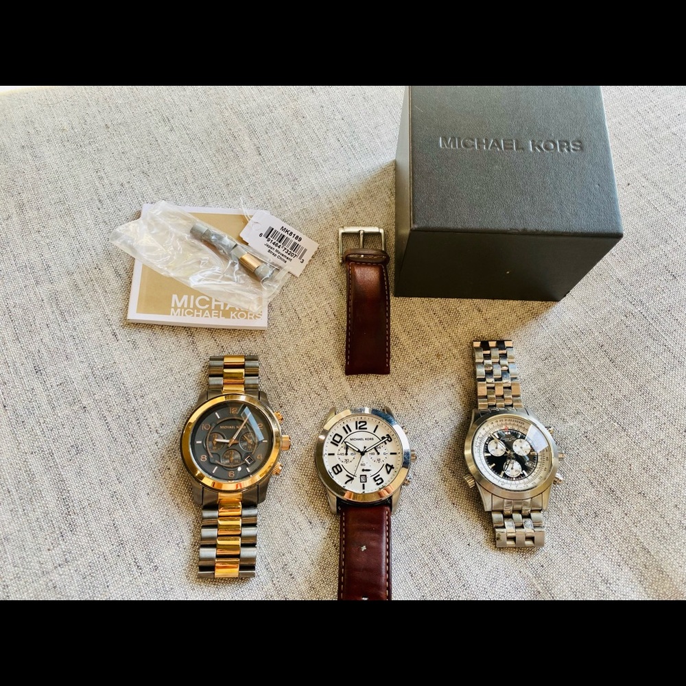 Two Michael Kors and one Kenneth Cole watch.